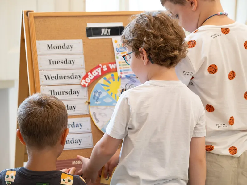 Kindergarten children at the days-of-the-week board
