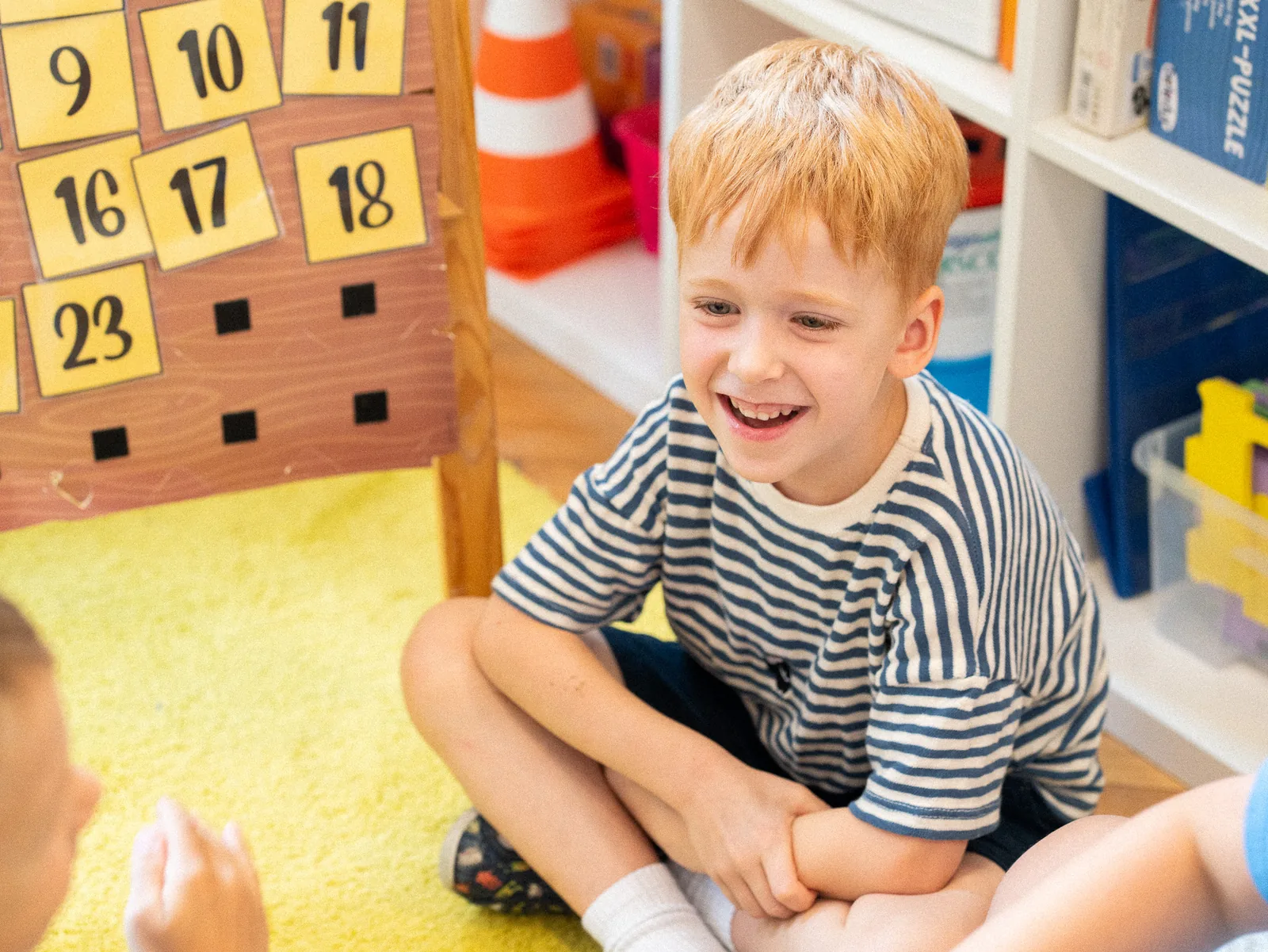 A Kindergarten boy laughing during class
